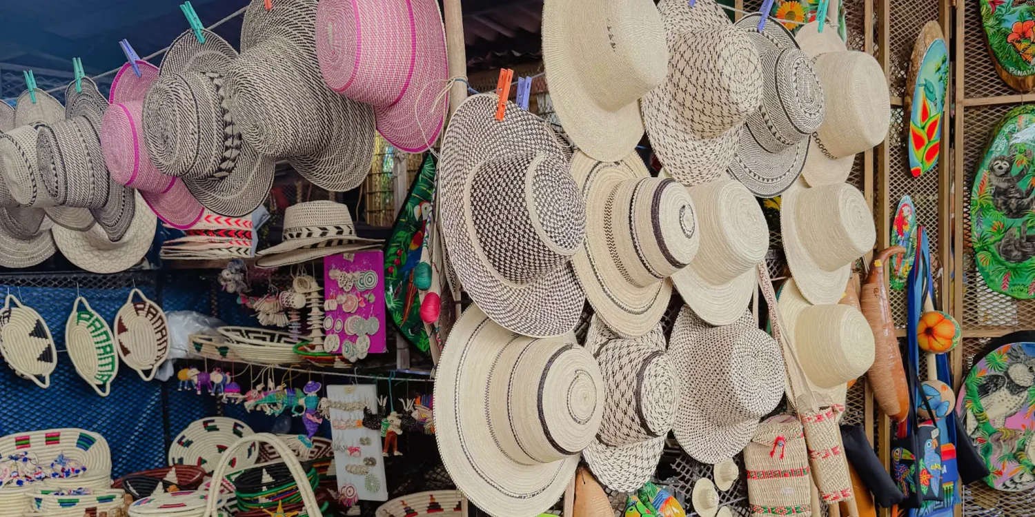 A market stall at the Valle de Anton Sunday market hung with Panama hats, woven baskets, and handmade crafts -- Valle de Anton Panama