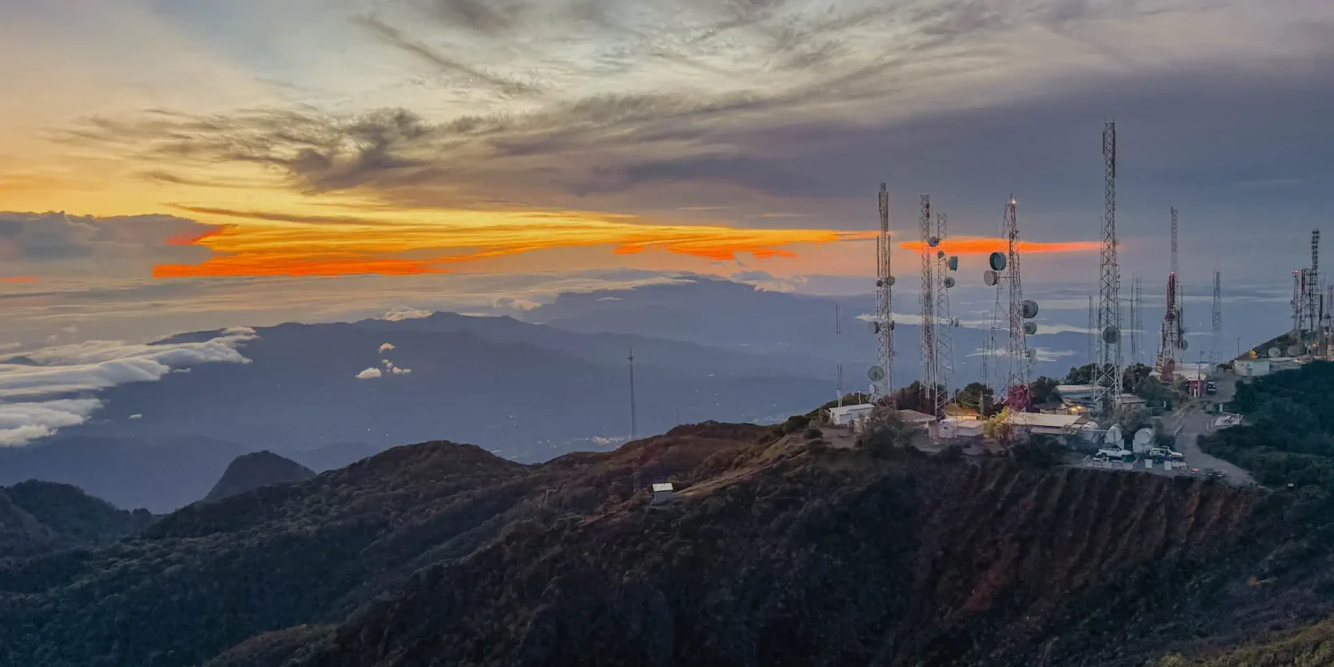 Fiery sunrise above the clouds from the summit of Volcan Baru with communication towers in the foreground -- Boquete Panama